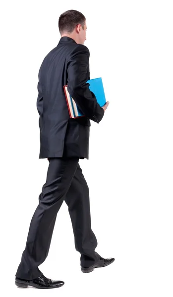 Vista posterior de pie de hombre de negocios con libros. — Foto de Stock