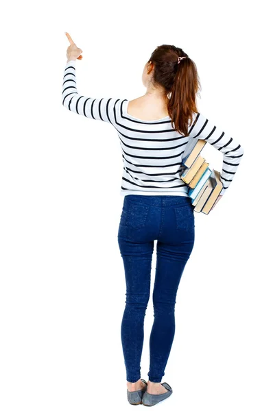 Menina com uma pilha de livros aponta o dedo. — Fotografia de Stock