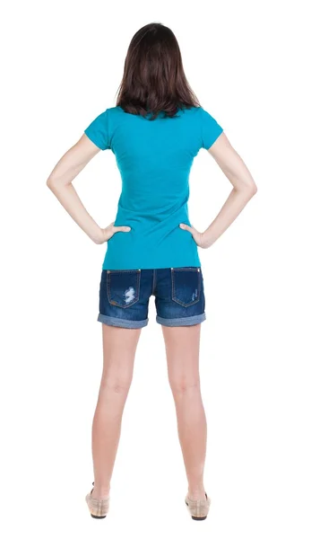 Back view of standing young beautiful  brunette woman in shorts. — Stock Photo, Image