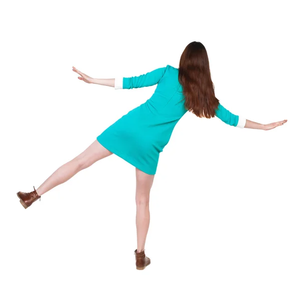 Mulher equilibra agitando os braços de vista traseira. — Fotografia de Stock