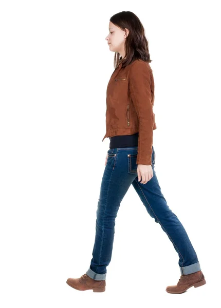 Back view of walking  woman in brown jacket. — Stock Photo, Image