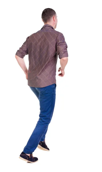 Back view of running man in brown shirt. — Stock Photo, Image