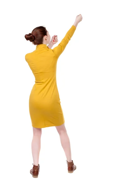 Back view of standing girl pulling a rope from the top or cling — Stock Photo, Image