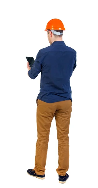 Backview of business man in construction helmet stands and enjoy — Stock Photo, Image