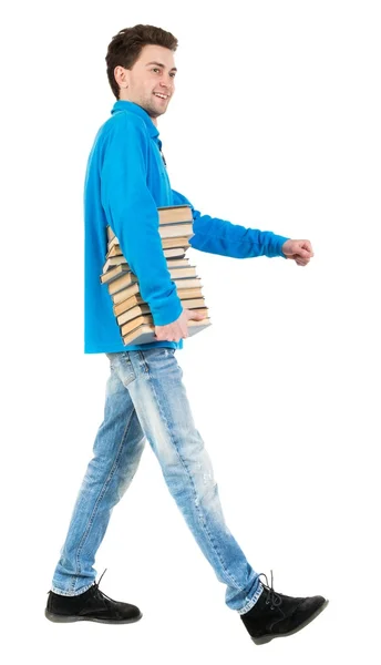 Vista do belo homem carrega uma pilha de livros traseira. — Fotografia de Stock