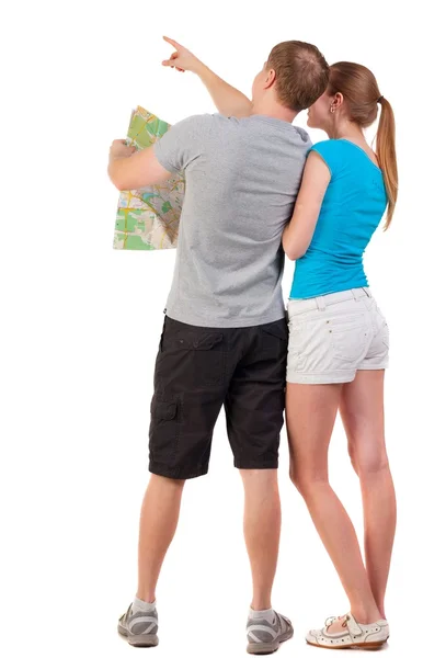 Back view journey of the young couple looking at the map. – stockfoto