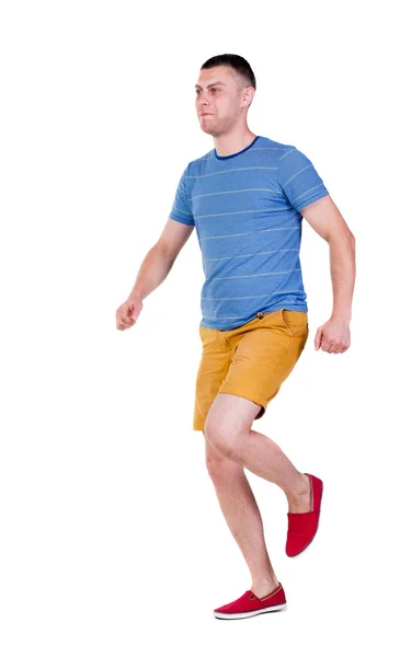 Back view of running man in t-shirt and shorts — Stock Photo, Image