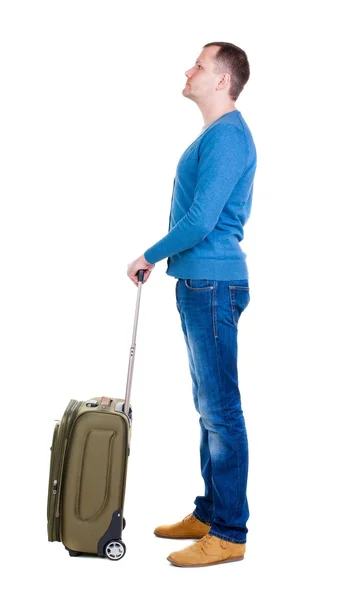 Back view of man with  green suitcase looking up. — Stock Photo, Image