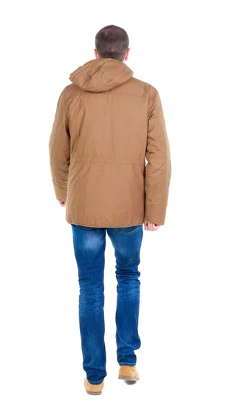 Back view of going  handsome man in brown parka. — Stock Photo, Image