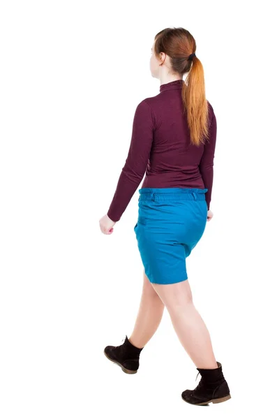 Side view of walking  woman in dress. beautiful girl in motion. — Photo