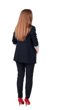 Arkadan redhead iş kadını düşünürken görünüşü.