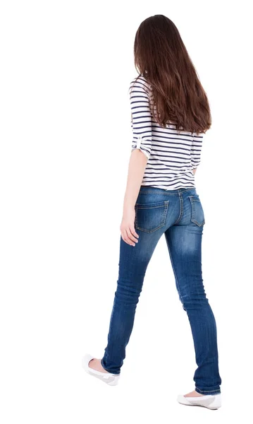 Back view of walking  woman in jeans — Stockfoto