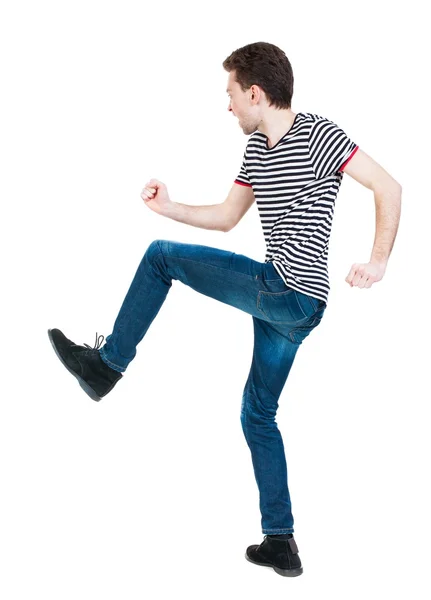 Back view of skinny guy funny fights waving his arms and legs. — Stock Photo, Image