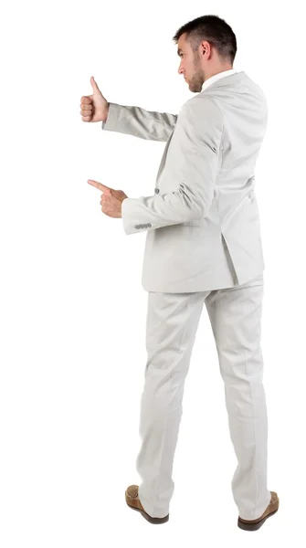 Vista posterior de joven empresario en traje blanco va pulgar —  Fotos de Stock
