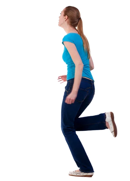 Back view of running  woman  in  jeans – stockfoto