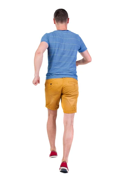 Back view of running man in t-shirt and shorts — Stock Photo, Image