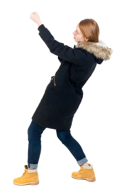 Sidovy. flicka i vinterjacka drar händerna ovanpå r — Stockfoto