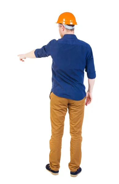 Back view of  pointing young men in  shirt and helmet. — Stock Photo, Image