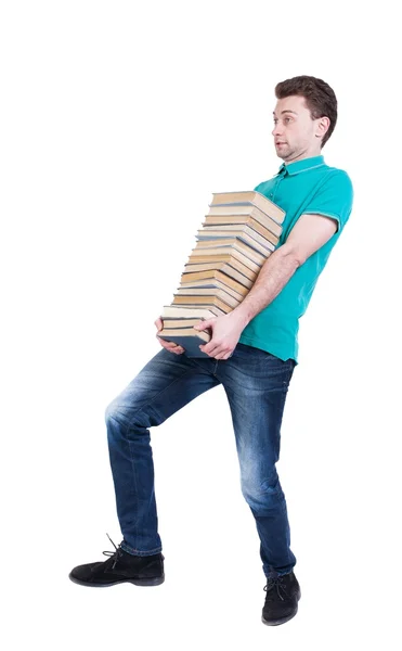 Back view of going  handsome man carries a stack of books. — Stock Photo, Image