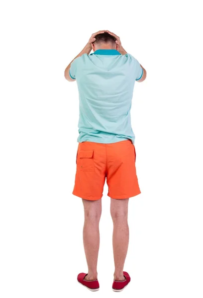 Vista posterior de joven enfadado en pantalones cortos y camiseta. — Foto de Stock