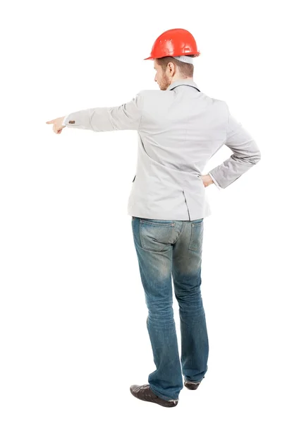 Back view of  pointing young men in helmet. — Stock Photo, Image