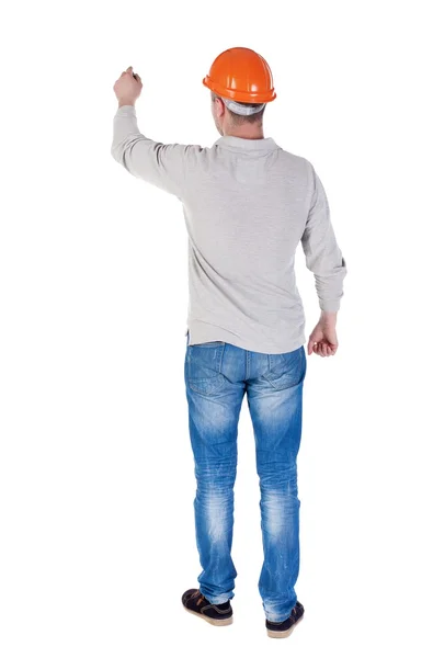 Back view of writing engineer in construction helmet. — Stock Photo, Image