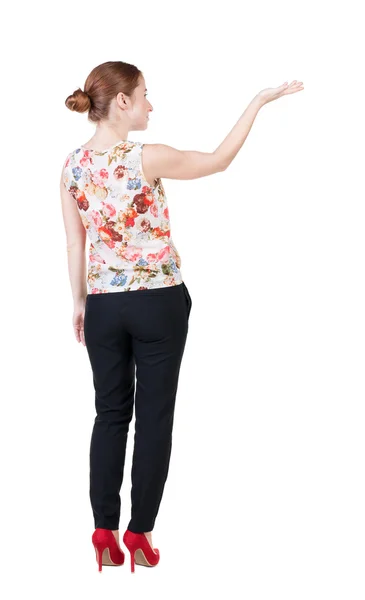 Woman in suite looking at wall and Holds hand up — Stock Photo, Image