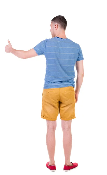 Back view of  man in checkered shirt shows thumbs up. — Stock Photo, Image