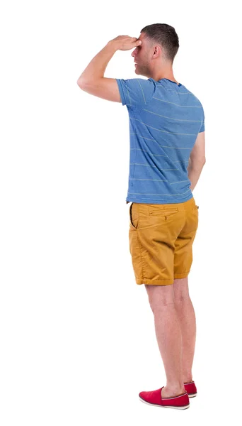 Rückansicht des jungen Manin Shorts suchen. — Stockfoto