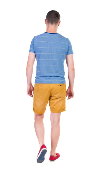 Back view of going  handsome man in shorts. - Stock-foto
