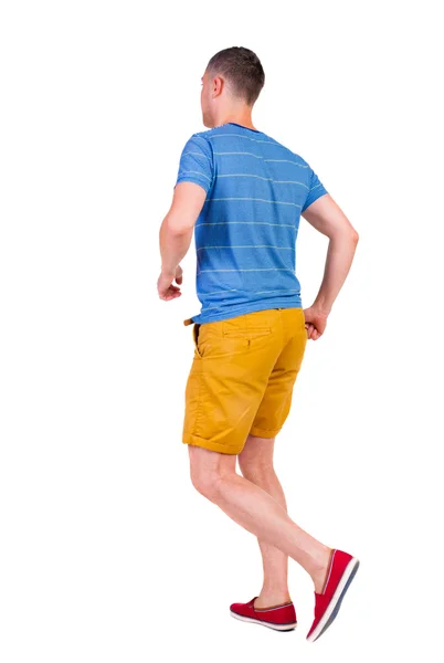 Back view of running man in t-shirt and shorts — Stock Photo, Image