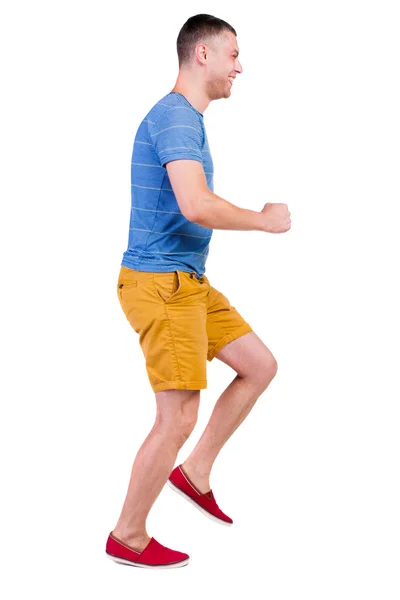 Rückansicht der Ausführung Mann in T-shirt und shorts — Stockfoto