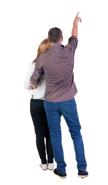 Young couple pointing at wal Back view — Stock Photo, Image