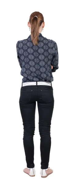 Donna in piedi in jeans vista posteriore — Foto Stock