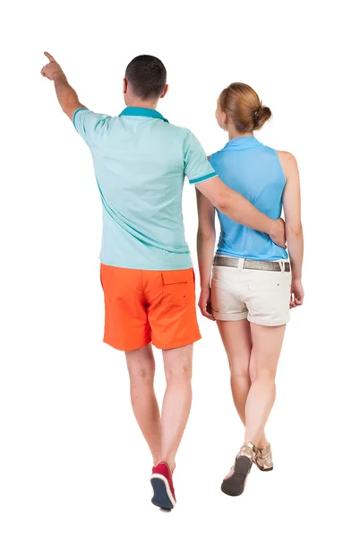 Walking and pointing young couple Back view — Stock Photo, Image