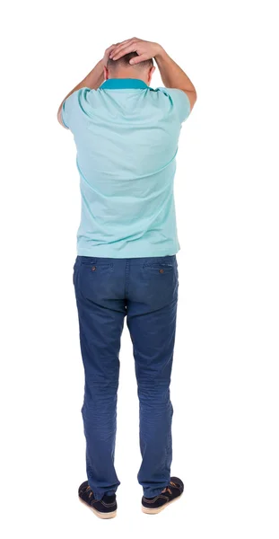Achteraanzicht van angry young man in jeans en t-shirt. — Stockfoto