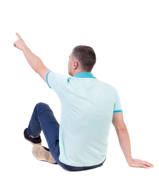 Back view of  pointing young men in  shirt and jeans. — Stock Photo, Image