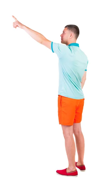 Back view of  pointing young men in  t-shirt and shorts. — Stock Photo, Image