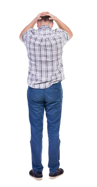 Back view of angry young man in jeans and shirt. — Stock Photo, Image