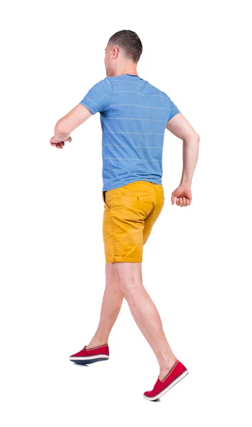 Back view of running man in t-shirt and shorts — Stock Photo, Image