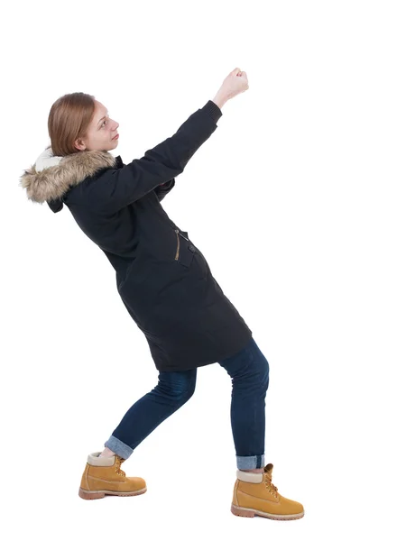 Woman in winter jacket pulls copy space — Stock Photo, Image
