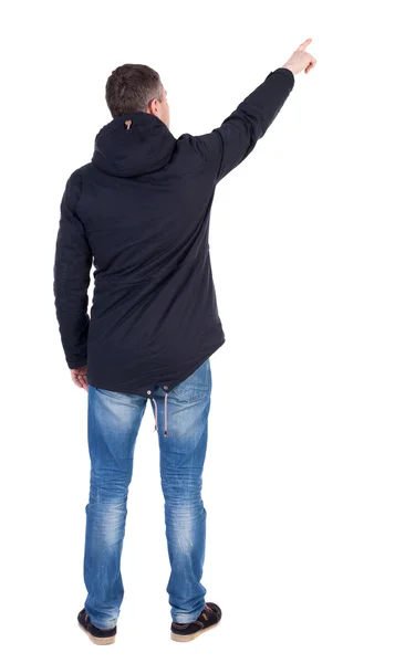 Young man in parka pointing away — Stock Photo, Image