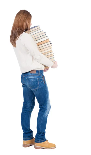 Frau trägt einen schweren Haufen Bücher — Stockfoto