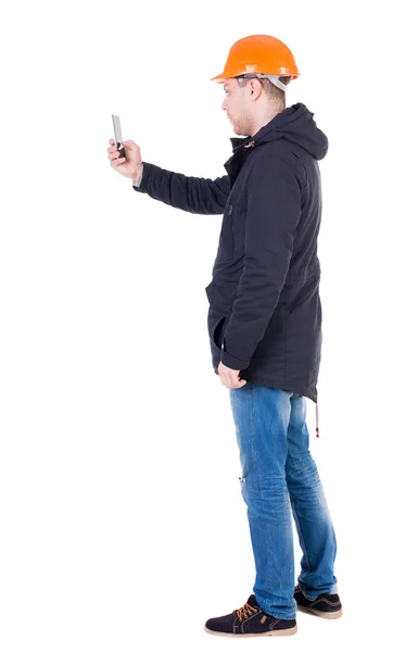 Engineer in helmet using a mobile phone — Stock Photo, Image