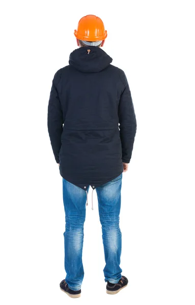 Vista traseira de um engenheiro na jaqueta e capacete — Fotografia de Stock