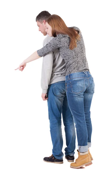 Casal jovem apontando para algo — Fotografia de Stock