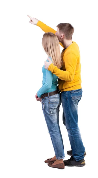 Casal jovem apontando para algo — Fotografia de Stock