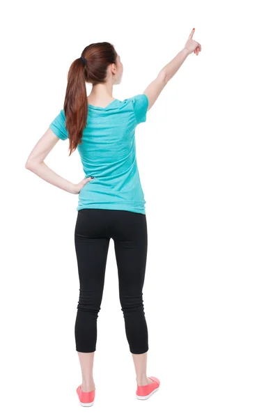 Pointing woman in sportswear. — Stock Photo, Image