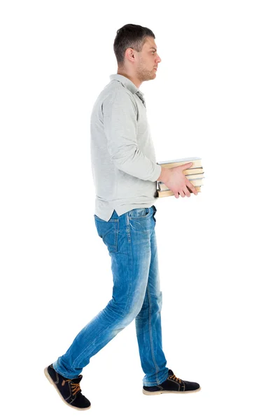 Handsome man carries stack of books. — Stock Photo, Image