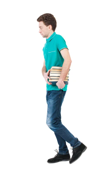 Homem bonito carrega a pilha de livros. — Fotografia de Stock